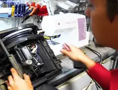 Vacuum repair technician servicing internal components on a workbench in Saint Louis, MO