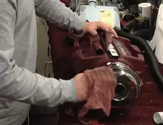 Vacuum repair technician cleaning and servicing a vacuum motor in Saint Louis, MO