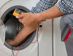 Washing machine repair technician testing a front-load washer with diagnostic tools in Saint Louis, MO